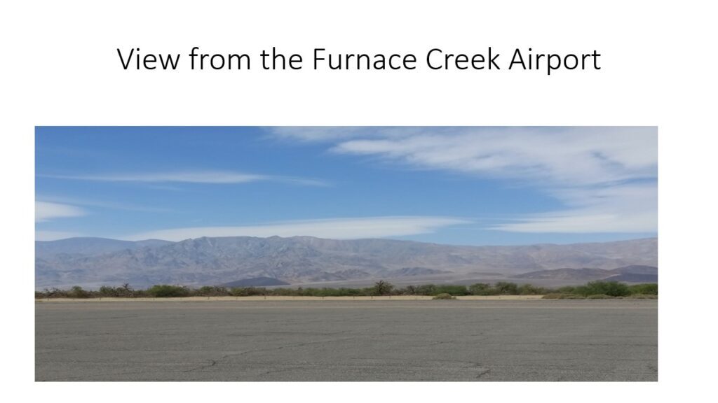 View of arid landscape and mountains from Furnace Creek Airport runway.