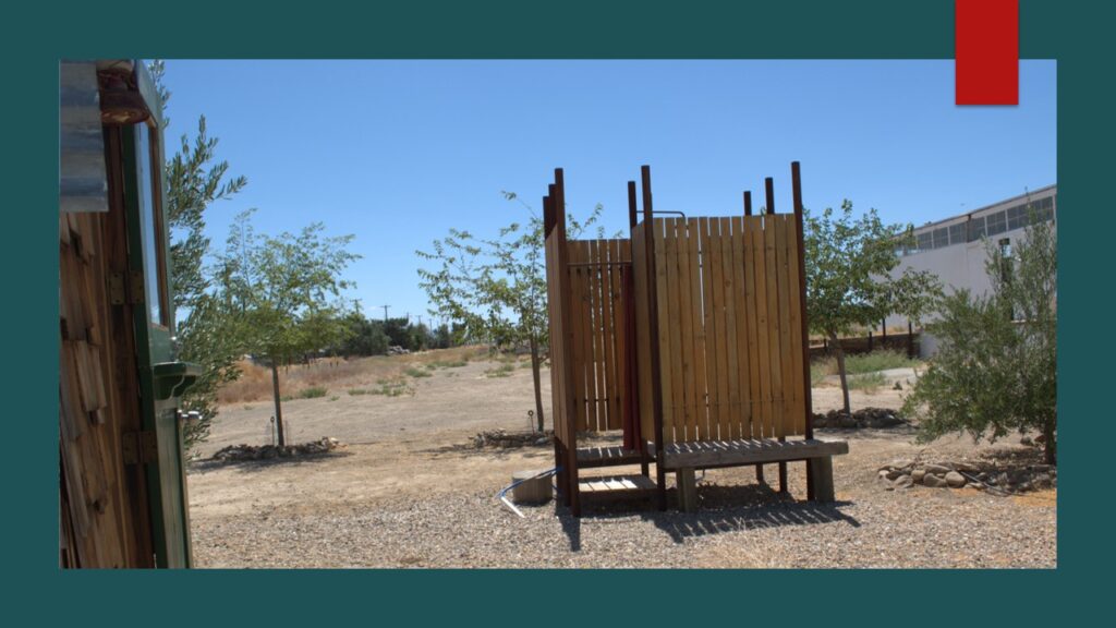 Empty road under a cloudy sky with distant trees.