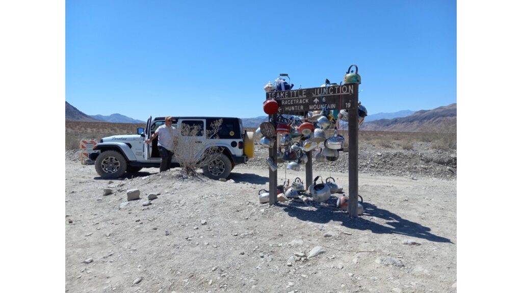 Man standing next to a small private airplane on a cloudy day.