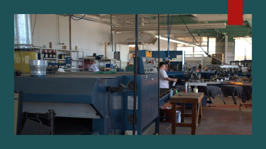 Man standing next to a small private airplane on a cloudy day.