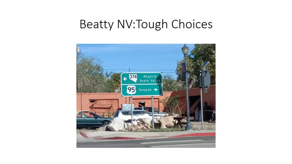 Confusing road signs at a busy intersection causing driver uncertainty.
