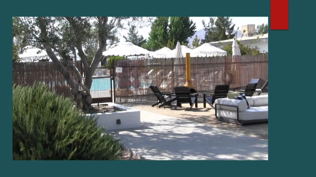 A large building under construction with ornate iron sculptures on top.